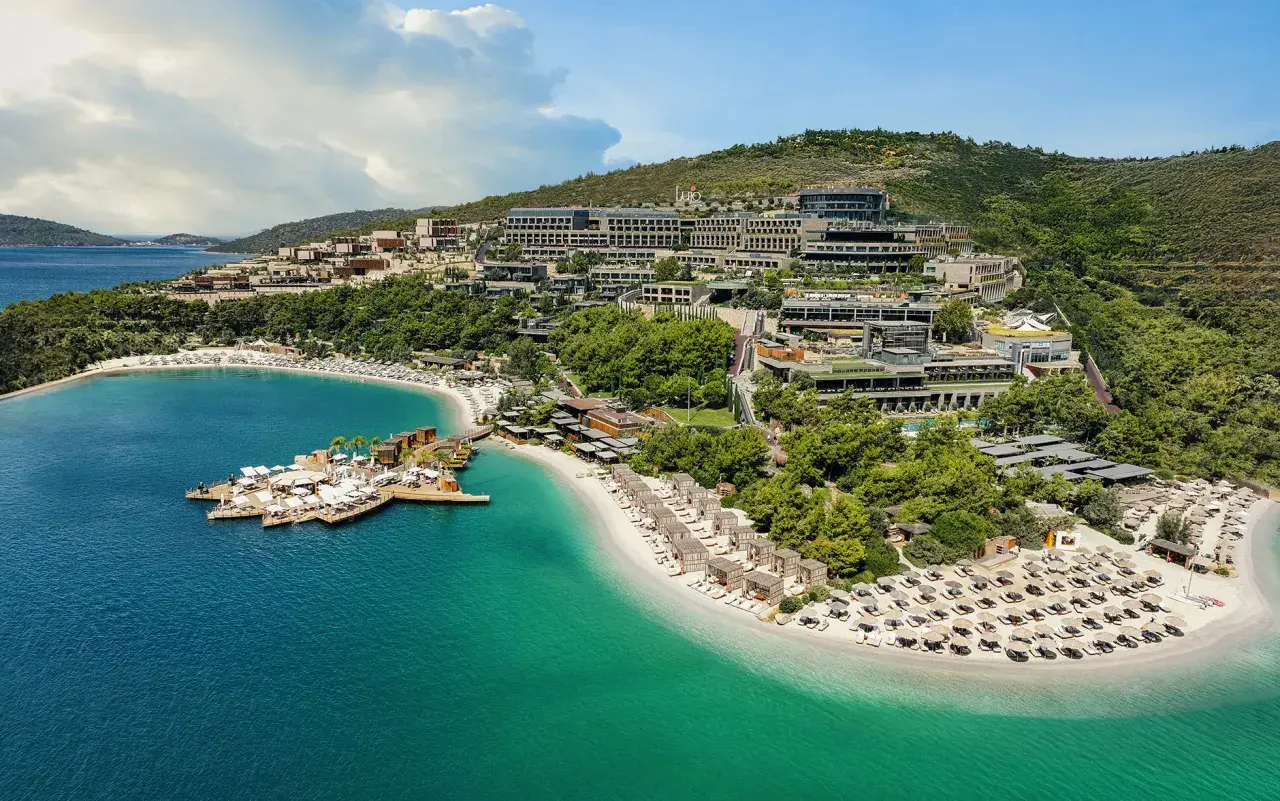 Luksusowy kurort nad turkusowym morzem, z plażą, pomostem i hotelami na zboczu wzgórza. Jedno z najlepszych miejsc na świecie.